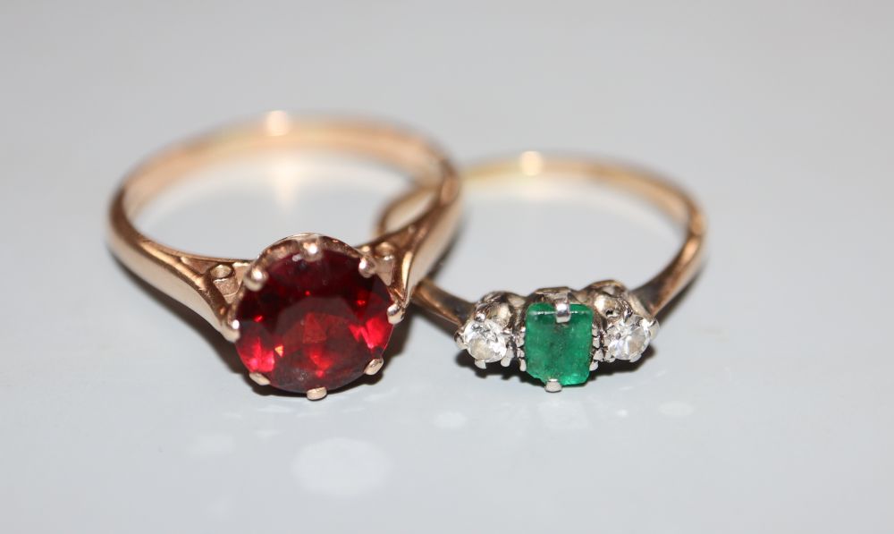 A yellow metal and plat, emerald and diamond three stone ring (emerald chipped) and a 9ct gold & garnet ring.